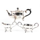 A matched three piece George V silver tea set, comprising: a tea pot, sugar bowl and milk jug,