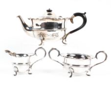 A matched three piece George V silver tea set, comprising: a tea pot, sugar bowl and milk jug,