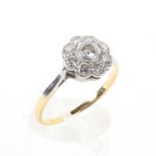 An 18ct gold and platinum diamond set flower ring.