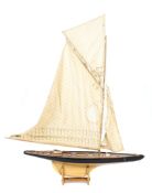 A large model pond yacht, on stand, with masted sails and rigging, 20th century,