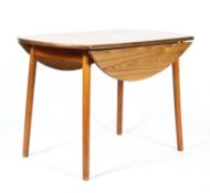 An Ercol-style elm veneered drop leaf dining table, of shaped circular form,