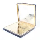 A vintage silver compact, of square, engine turned form,