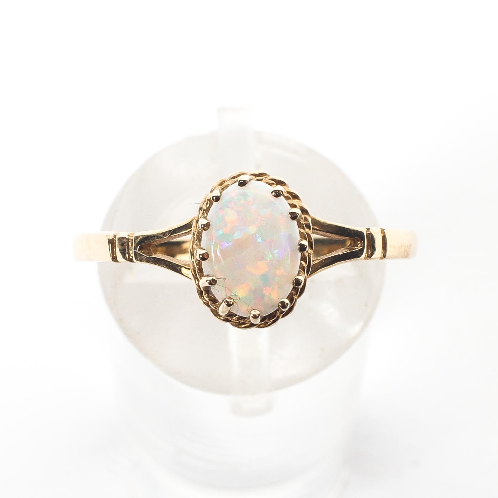 A 9ct gold and opal ring set with single oval cabochon opal in a prong setting. Size R, 1.4g. - Image 2 of 4