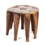 A mid to late 20th century 'Nupe' West African/ Nigerian eight legged stool with geometric carved