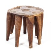 A mid to late 20th century 'Nupe' West African/ Nigerian eight legged stool with geometric carved