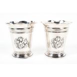 A pair of Edwardian silver floral fluted vases, cylindrical form with flowing ring,