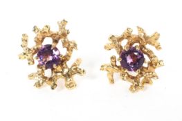 A pair of 9ct gold and amethyst set stud earrings with pierced abstract design, circa 1975, 4.6g.