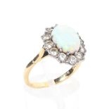 An 18ct gold and platinum opal and diamond dress ring.