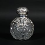 A large silver mounted cut-glass perfume bottle and hinged cover,