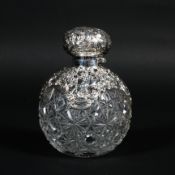 A large silver mounted cut-glass perfume bottle and hinged cover,