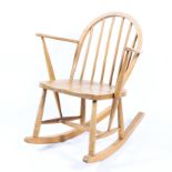 An Ercol rocking chair in light beech and elm, blue label to reverse,