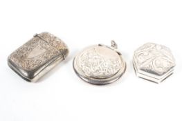 A late Victorian silver vesta case with a British silver import pill pot and another silver pot