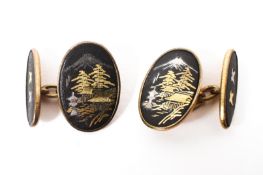 A pair of unmarked yellow metal and black enamel cuff links,