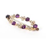 A 9ct gold amethyst and seed pearl brooch. 2.5g.