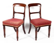 Six Victorian (Holland & Sons) mahogany dining chairs, with curved top tail and foliate carved back,