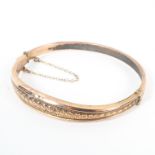 A 9ct gold hinged bangle