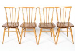Four Ercol spindle back chairs in light beech and elm, on tapering legs