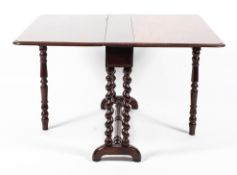 A Victorian folding gateleg table on barley twist supports and arched feet,