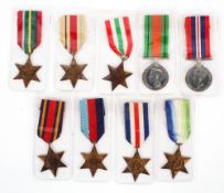 A collection of WWII medals, including Atlantic Star, Pacific Star, Burma Star,