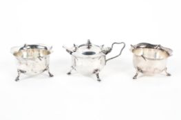 A three piece condiment set, two open salts and a lidded, single handled mustard,