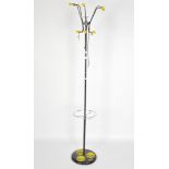 A vintage coat and umbrella stand, five yellow tipped hooks to the top,