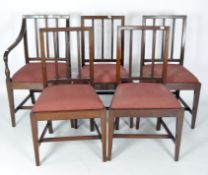 Four dining chairs and one carver with upholstered drop in seats,