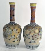 A pair of Japanese ceramic vases, of globular form, with tapering necks,