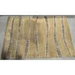 A large beige contemporary wool rug,