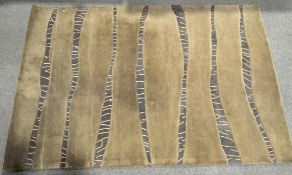 A large beige contemporary wool rug,