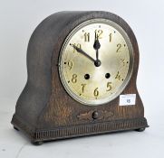 An early 20th Century mantel clock, silvered dial with Arabic numerals,