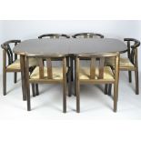 A Danish dining table and six chairs, the table with two additional leaves,