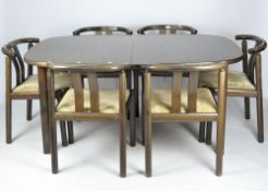 A Danish dining table and six chairs, the table with two additional leaves,