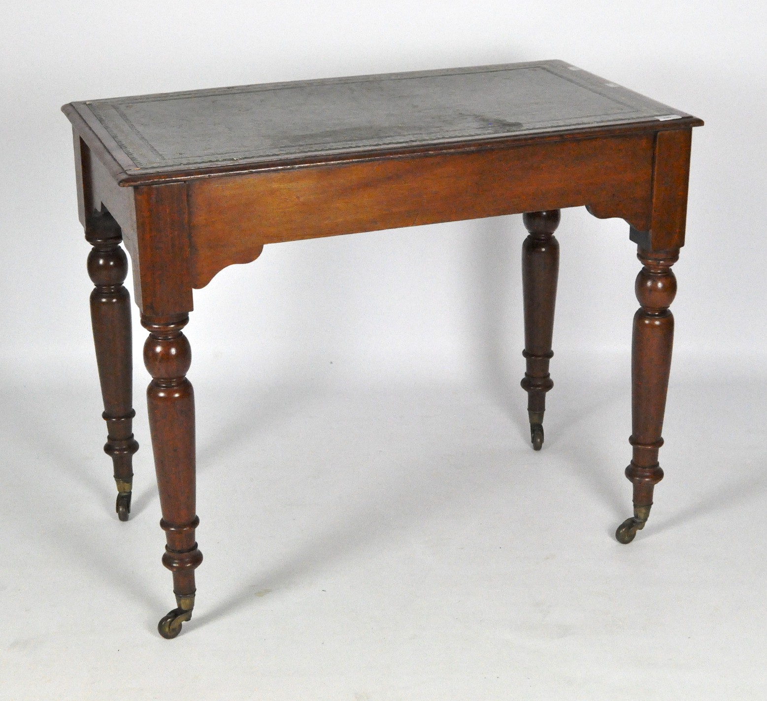 A Victorian mahogany side table, with a green leather inlay to the top and turned supports,