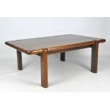 A contemporary wooden coffee table, with curved edges and supports,