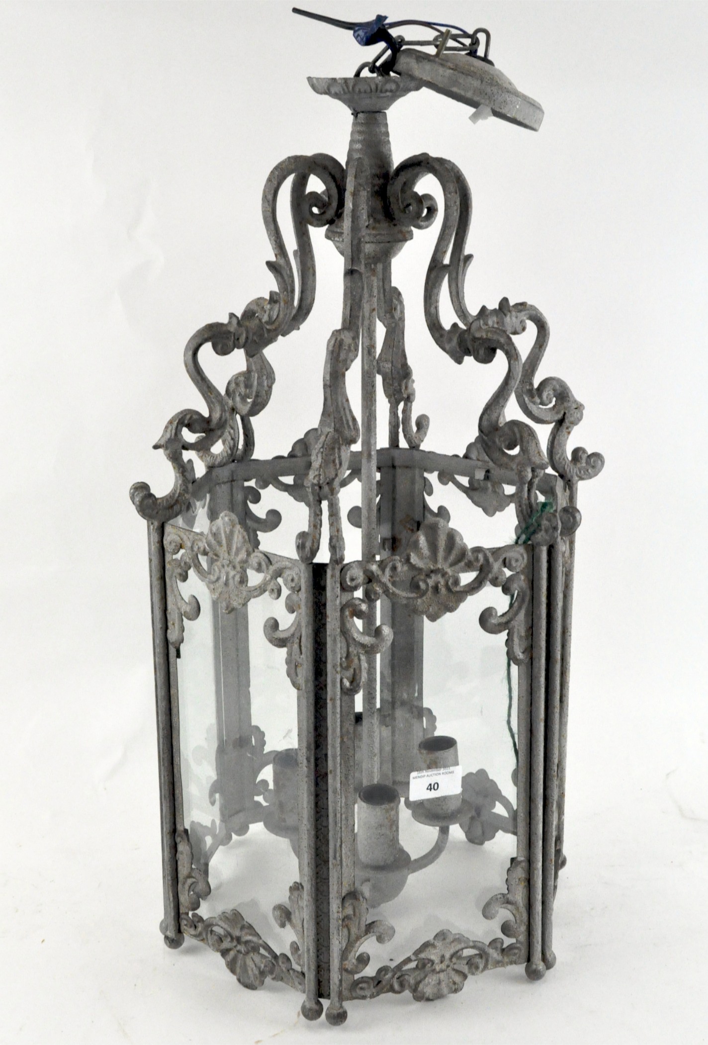 A large ornate metal hanging lantern, of hexagonal form, each side fitted with a glazed panel,