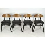 A set of four retro dining chairs, black leatherette seat, raised on black painted supports,