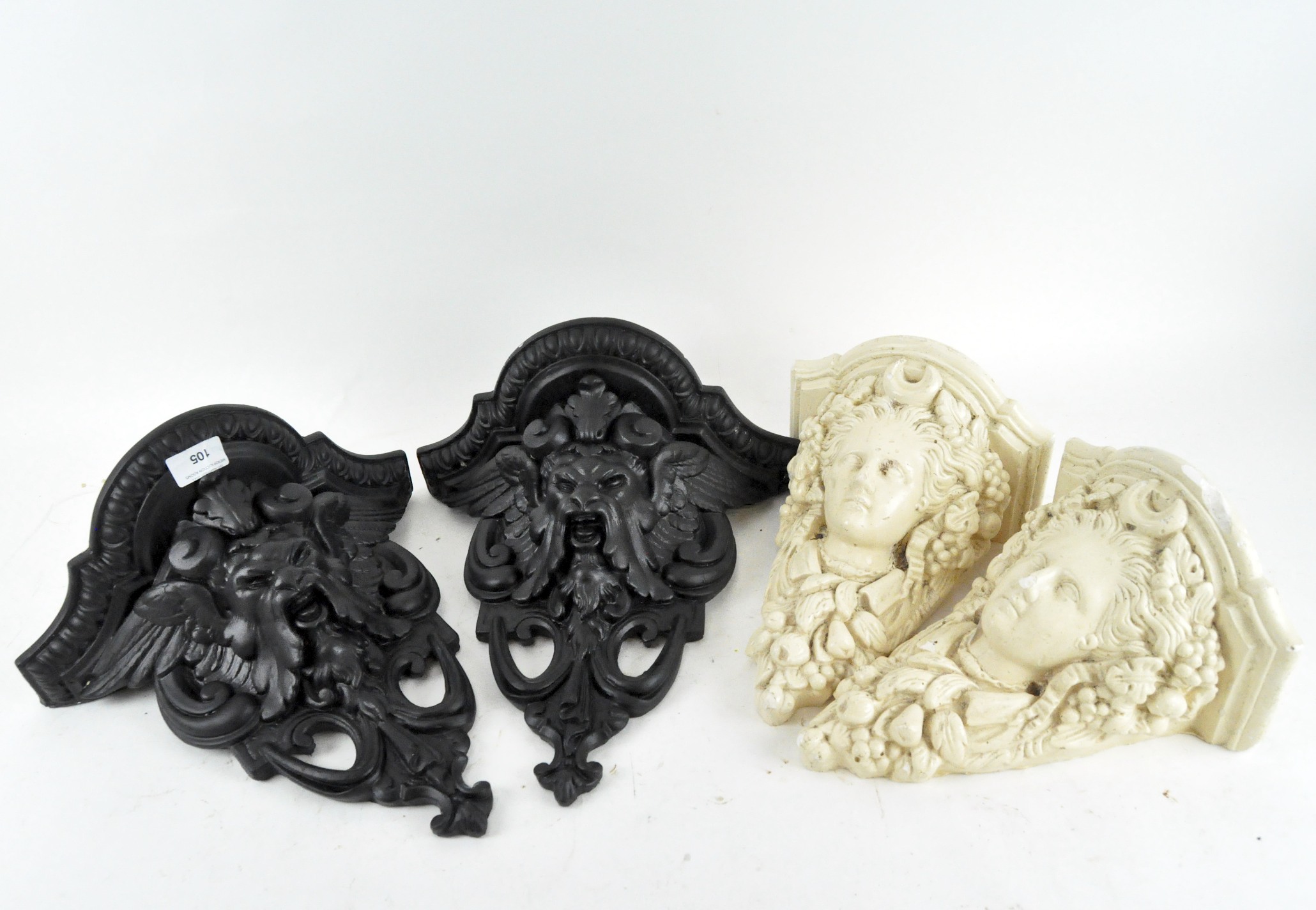 A pair of resin wall brackets with a pair of cast metal wall brackets