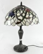 A vintage Tiffany style table lamp, with leaded glass floral shade,