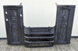 A cast iron Victorian fireplace moulded to the side panels and below the grate with baskets and