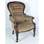 A 19th Century mahogany spoonback armchair, with brown velvet upholstery and buttons,