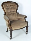 A 19th Century mahogany spoonback armchair, with brown velvet upholstery and buttons,