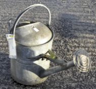A galvanised watering can,