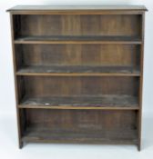 An early 20th century oak bookcase, with four fixed shelves,