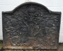 A large cast metal fire back with domed top, moulded with an oak tree and the initials C and R,