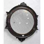 A Victorian mahogany veneer bevelled edge wall mirror, of circular form,