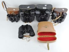 Five pairs of vintage binoculars, including a pair of Sunex 10x35 and a pair of Zenith 8x50,