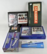 A small collection of games, DVDs and other items including: Scrabble, Grand Prix DVD and book set,