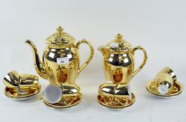 A Royal Worcester gold coloured coffee set including eight cups and saucers,