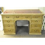 A late 19th/early 20th century pine pedestal desk, the leather top with gilt tooled borders,