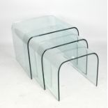 A contemporary heavy set of three graduating glass coffee tables,